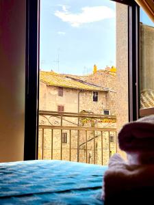 a view from a bedroom window of a building at Nazareth Residence in Viterbo