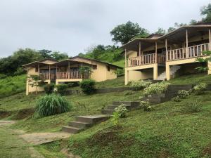 a group of houses on a hill with stairs at Gatun Lake Lodge Hotel in Pueblo Nuevo