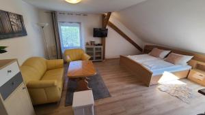a small living room with a bed and a couch at Rooms 4 Holiday in Kirchbach