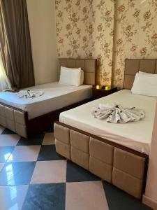 two beds sitting next to each other in a room at New Abdeen palace hostel in Cairo