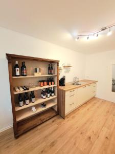 a room with a shelf with wine bottles at Stammhaus - somnium Appartements Südsteiermark in Weitersfeld an der Mur +10 photos