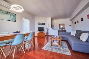 a living room with a couch and a table at Aiyra Beach House in Costa da Caparica