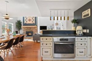 a kitchen and dining room with a table with chairs at Modern/Rustic 2 Story Condo/3 Min Walk to Village in Blue Mountains