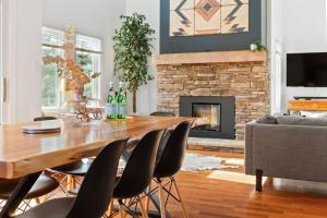 a living room with a table and chairs and a fireplace at Modern/Rustic 2 Story Condo/3 Min Walk to Village in Blue Mountains