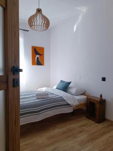 a bedroom with a bed and a pendant light at Klimatyczne Apartamenty Złoty Stok in Złoty Stok