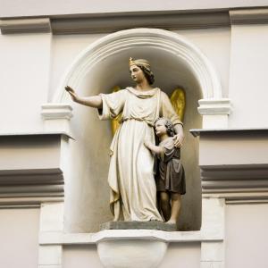a statue of a woman and a child on a building at The ICON Hotel & Lounge in Prague