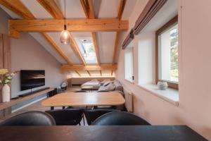 a room with a table and chairs and a couch at Vista 18 by Správa ubytka in Rokytnice nad Jizerou
