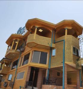 a tall building with balconies on the side of it at Victorus Homes in Freetown