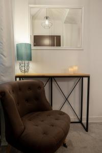 a chair in front of a desk with a mirror at Apartament Sun Hill in Wisła +5 photos