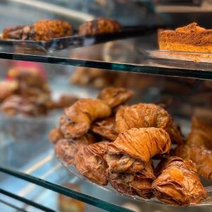 a display case filled with lots of croissants and other pastries at Elite del Centro Storico in Naples