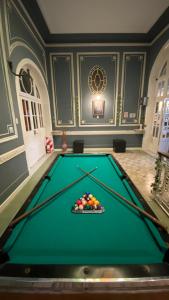 a pool table in a large room with afits at Hostel Alvear in Cordoba