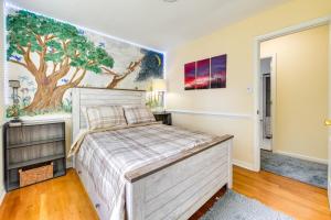 a bedroom with a bed and a tree mural at 8 Mi to Richmond Pet-Friendly Vacation Rental! in Mechanicsville