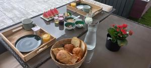 un tavolo con vassoio di pane e un piatto di cibo di Chambre indépendante piscine en saison petit déjeuner inclus a Véretz