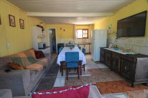 a living room with a table and a couch at Chácara do Sapé in São José dos Pinhais