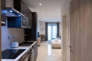 a kitchen with a sink and a counter top at Lennox Beautiful Suite @Airport Residential in Accra