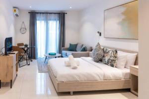 a bedroom with a large bed and a living room at Lennox Beautiful Suite @Airport Residential in Accra +121 photos