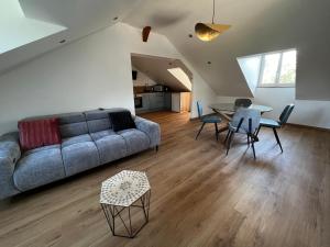 a living room with a couch and a table at Domaine de Val combe in Dole