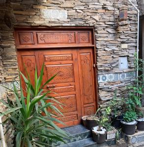 a wooden door on the side of a stone building at Z Pyramids Inn in Cairo