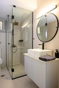 a bathroom with a sink and a mirror at Philoxenia Luxury Apartment in Kritsa