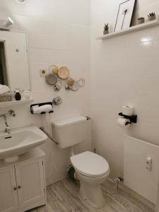 a white bathroom with a toilet and a sink at Sweet Home - 3 - in Moers +4 photos