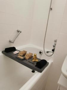 a bath tub with a shelf in a bathroom at Sweet Home - 3 - in Moers