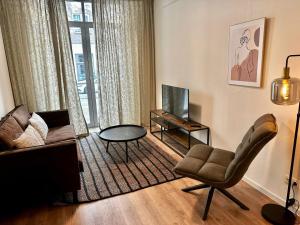 - un salon avec un canapé et une chaise dans l'établissement Charming 1 bedroom serviced apartment 57m2, à Rotterdam