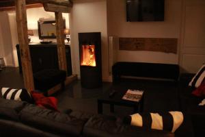 a living room with a couch and a fireplace at Sallinghaus in Eslohe