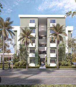 un edificio con delle palme di fronte di LACIOCHICAPARMENT a Hainamosa