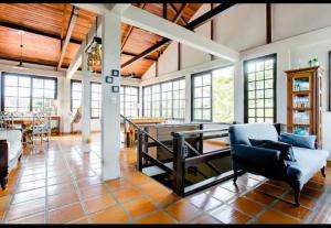 a large living room with a table and chairs in it at The Cats' House in Florianópolis