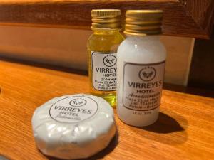 two bottles of vinegar and honey on a wooden table at VIRREYES HOTEL in Potosí