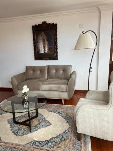 a living room with a couch and a table at VIRREYES HOTEL in Potosí