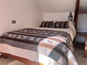 a bedroom with a bed with a colorful bedspread at VIRREYES HOTEL in Potosí