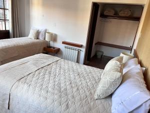 a hotel room with two beds and a window at VIRREYES HOTEL in Potosí