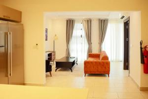 ein Wohnzimmer mit einem Sofa und einem Tisch in der Unterkunft Lovely 2 Bedroom Loft/Duplex - Labone in Accra