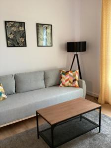 a living room with a couch and a coffee table at Chopin airport Apartment in Warsaw