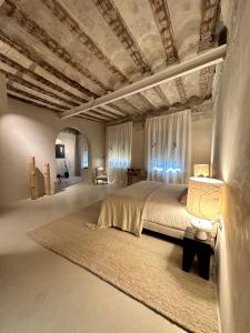 a bedroom with a large bed with a coffered ceiling at Hotel Avenida in Zaragoza