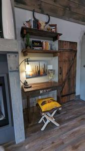 a room with a desk with a lamp and a stool at Enjoy Ozark History in Style! in Hasty