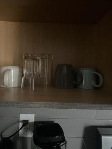 a kitchen counter with glasses and appliances on it at Home for yourself in Winnipeg