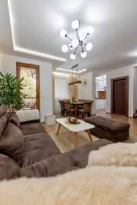 a living room with a couch and a table at Apartman Gačanović Lux in Zlatibor