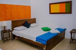 a bedroom with a large bed with blue cushions at Star Dambulla in Dambulla