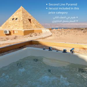 a pool of water in front of a pyramid at Deadsea OCTAGON in Madaba