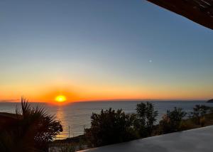 a sunset over the ocean from a house at Blue Sea Villa in Serifos Chora