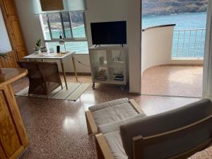a living room with a couch and a table with a tv at Apartamento Playa San Marcos in Icod de los Vinos