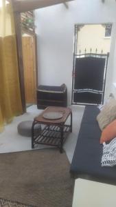 a living room with a couch and a table at Au PasSage in Monchy-Humières