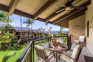 a patio with a table and chairs on a balcony at Kona Makai 5307 in Kailua-Kona