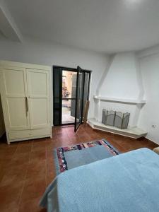 a bedroom with a bed and a room with a window at Vila Zara in Gevgelija