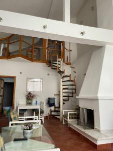 a living room with a spiral staircase in a house at Vila Zara in Gevgelija