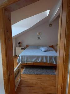 a bedroom with a bed and a sloped ceiling at Vila Zara in Gevgelija