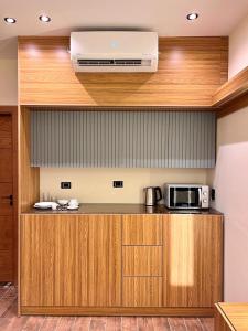 a kitchen with a counter with a microwave and a stove at Elite Hospitality in Cairo