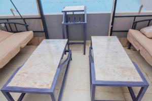 a pair of blue tables on a balcony at Belle Vue in Bujumbura